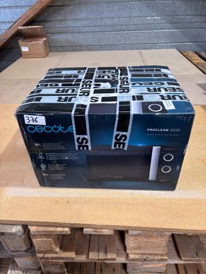 a box that has a microwave on it on a table