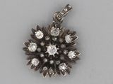 an image of a diamond flower pendant on a silver chain