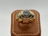 an image of a gold ring with a diamond on it