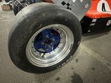 a close up of a race car with a big tire