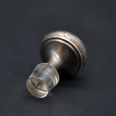 a close up of a metal object on a black surface
