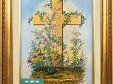 an oil painting of a cross and flowers in a gold frame