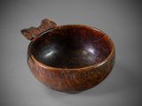 wooden bowl with writing on it sitting on a gray surface