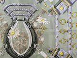 a green scarf with a picture of a horseshoe and flowers on it