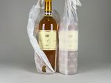 two bottles of wine sitting next to each other on a table
