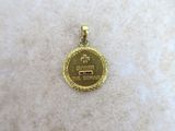 a close up of a gold medal on a white surface