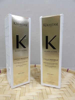 two bottles of kerastasee kerattasee hair conditioner sitting on a basket