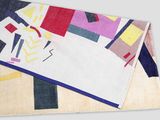 the blanket is multicolored and has a geometric design on it