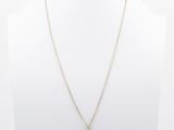 a gold necklace with a green stone pendant on a mannequin