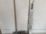 a bucket and a shovel on the floor next to a wall