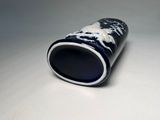 a blue and white vase sitting on a white surface