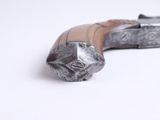a close up of a metal object on a white surface