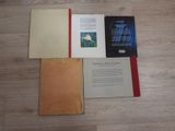 three books are sitting on a wooden floor next to each other