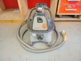 a vacuum that is sitting on the floor in the room