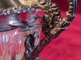 a silver cup with a handle on a red table