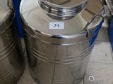 two stainless steel pots sitting on the floor next to a cardboard box