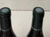 three bottles of wine sitting on a counter top