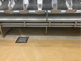 a row of empty benches in a public restroom