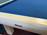 a pool table with a blue cloth on it