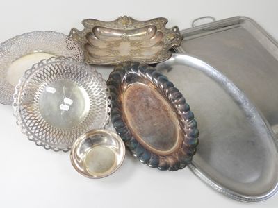 a lot of silver dishes and trays on the table