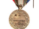 medal with ribbon and pin attached to it on a white background