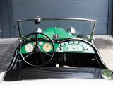 a green car with a steering wheel and a clock on the dashboard