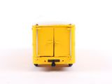 a yellow toy truck that is sitting on a white surface