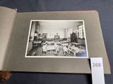 an old photo of a school room with a teddy bear