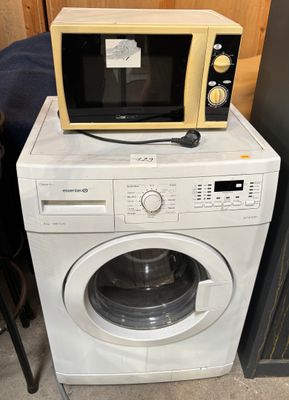 a microwave sitting on top of a washing machine
