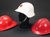 three red and white hard hats sitting on top of a mannequin head