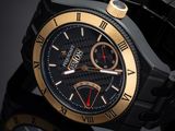 the black and gold watch is on a black surface