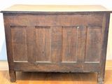 a wooden chest sitting on a hard wood floor