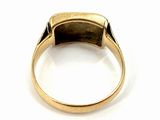 a close up of a gold ring with a stone in the middle