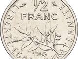 a close up of a coin with a bird on it