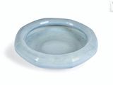 a blue bowl that is sitting on a white surface