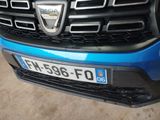 a close up of a front bumper of a blue car