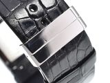 the watch is black and has a silver buckle on it