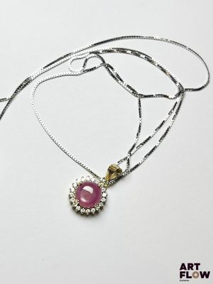 un gros plan d'un collier orné d'une pierre rose