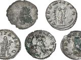 a group of four ancient roman coins on a white background
