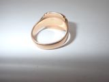 a gold ring sitting on top of a white table