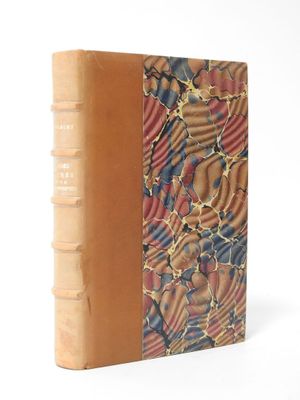 an old book sitting on top of a white table next to a white wall