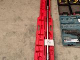 a red tool case and a wrenet on the floor