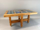 a wooden table with blue tiles on top of it