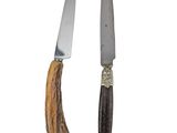 two knives with antelope handles are next to each other on a white background