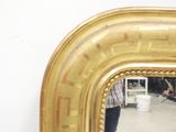 a mirror that is sitting on a table in a room