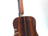 an image of a wooden guitar on a stand against a white background
