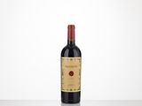 a bottle of red wine sitting on top of a table
