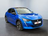 a blue car parked in a room with a white wall