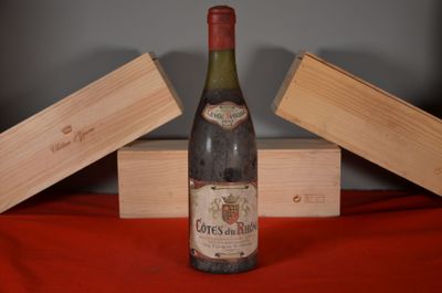 a bottle of wine sitting on a table next to two wooden boxes