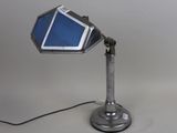 an image of a desk lamp with a cell phone on it